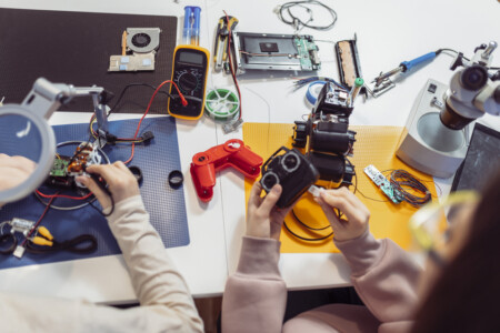 Close Up Photo Of Children Making Robot At Home.