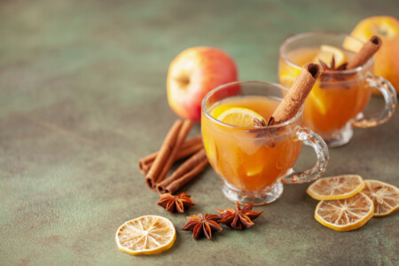 Homemade Wassail Mulled Apple Cider With Lemon And Spices In Glasses. Winter Alcoholic Hot Drink.