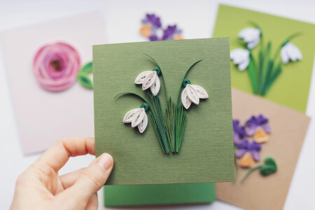 Hand Holding Quilling Card With Snowdrops Flowers. Woman Making