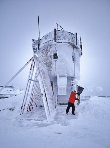 2022 02 04 Will Intern Finsihing Up Shoveling The Instrument Tower Exit As The Sun Dimly Backlights The Tower
