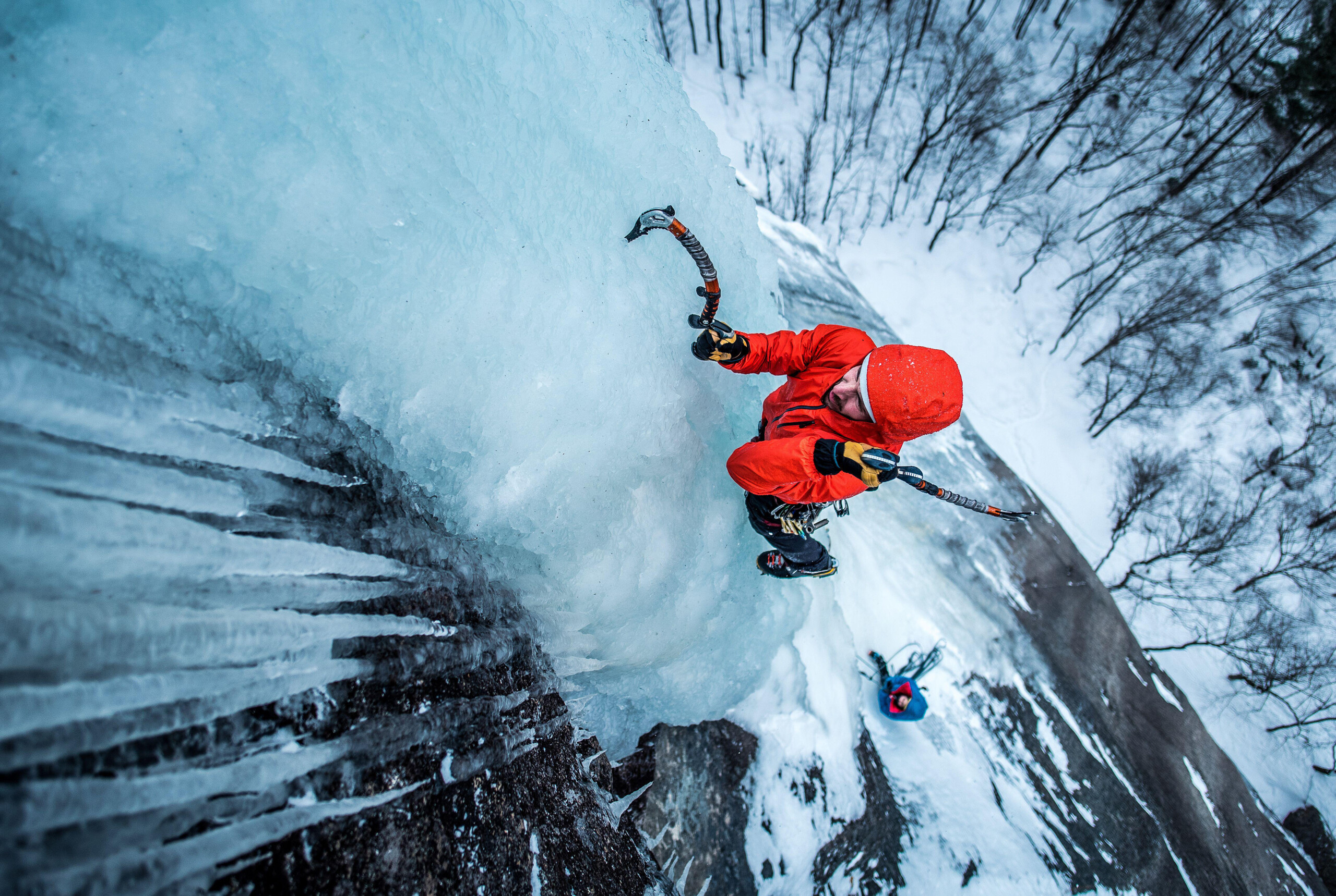 Man Ice Climbing On Cathedral Ledge In North Conway, New Hampshire